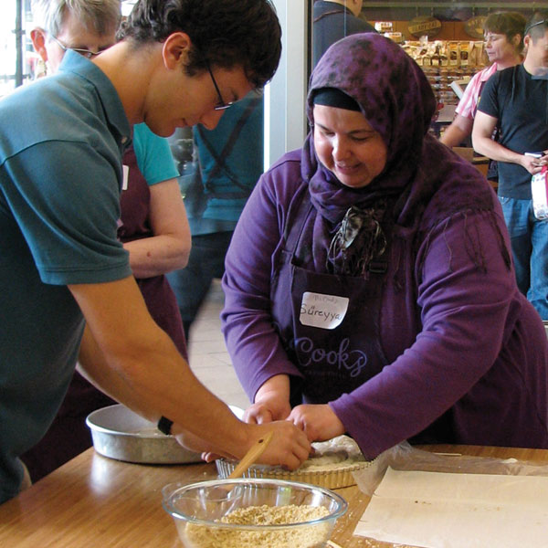 Sureyya Gokeri, who is from Turkey, instructs a PCC Cooks student.