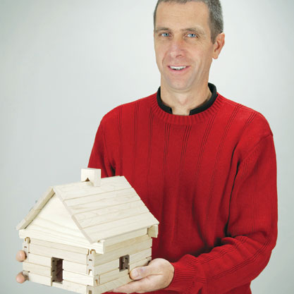 Andrew Peters with his award-winning Cozy Cabin building set.