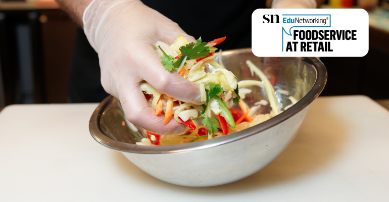 A chef hand mixing a salad (1).png