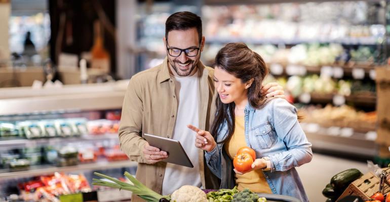 Grocery shoppers checking prices