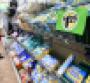 A shopper looks at product in a grocery aisle.jpg