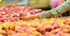 Supermarket consumer shops for peaches