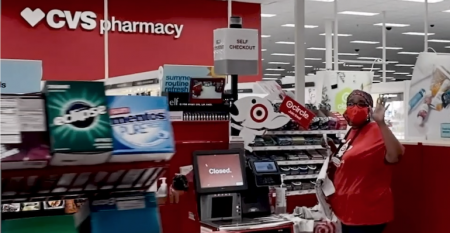 Target_checkout_worker-CVS_Pharmacy_sign.png